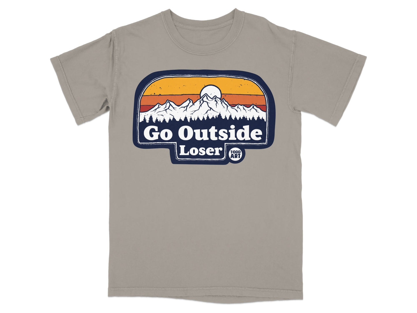 "Go Outside Loser" text with mountains and sun graphic on a taupe t-shirt.