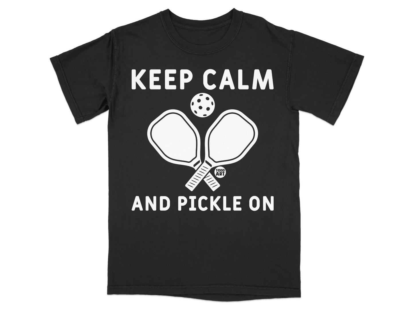 Black t-shirt with "KEEP CALM AND PICKLE ON" and pickleball paddles.