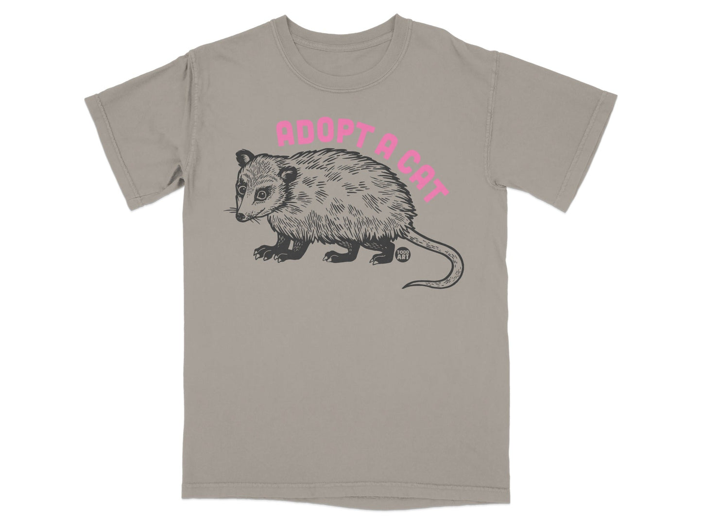 Opossum wearing a pink "Adopt a Cat" graphic t-shirt.