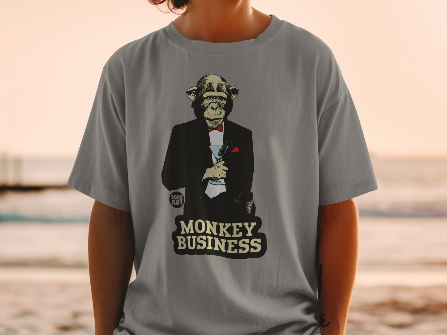 Monkey in a tuxedo holding a martini, "MONKEY BUSINESS" text.