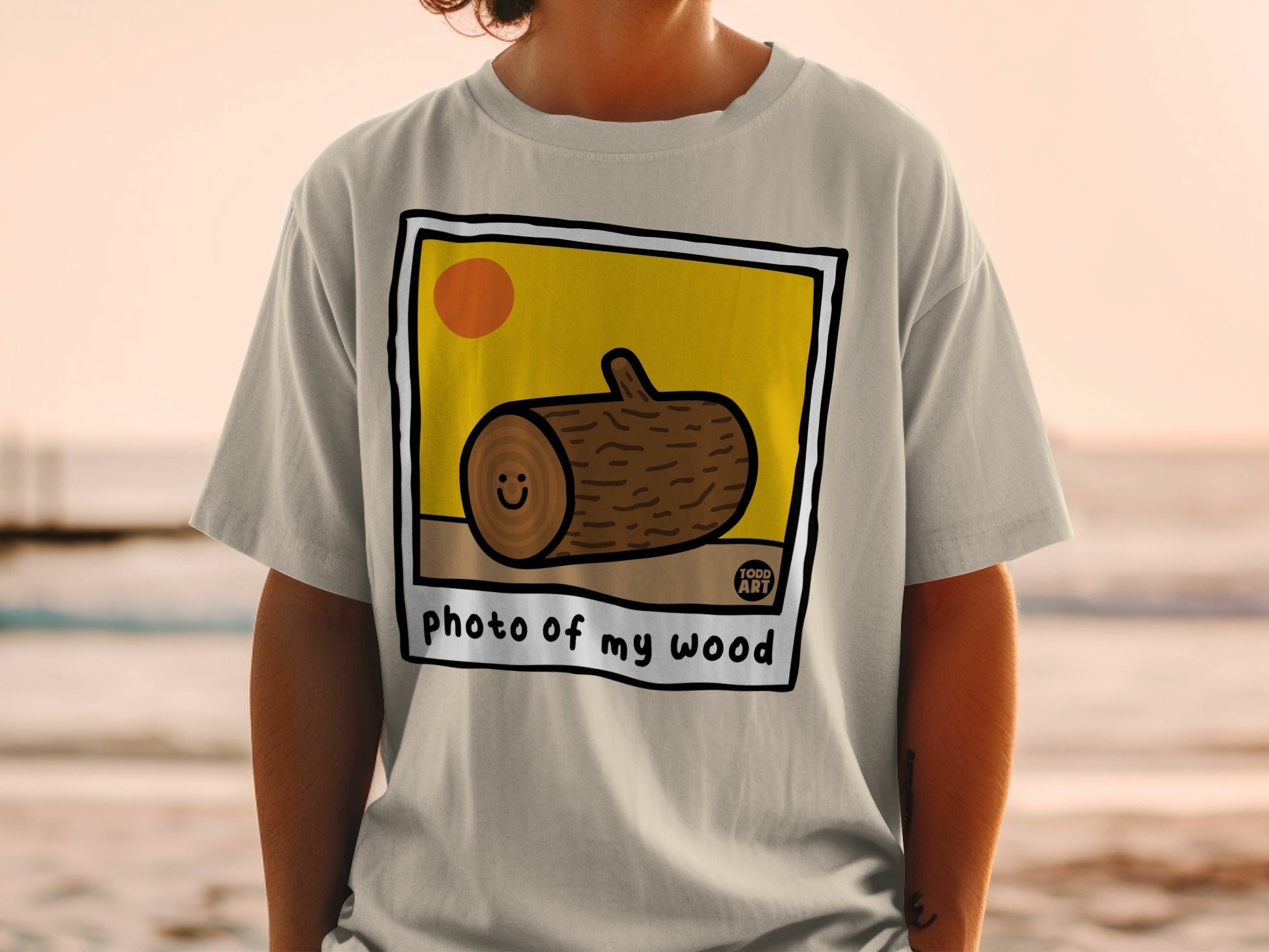 T-shirt with cartoon wood log, sun, and text "photo of my wood".