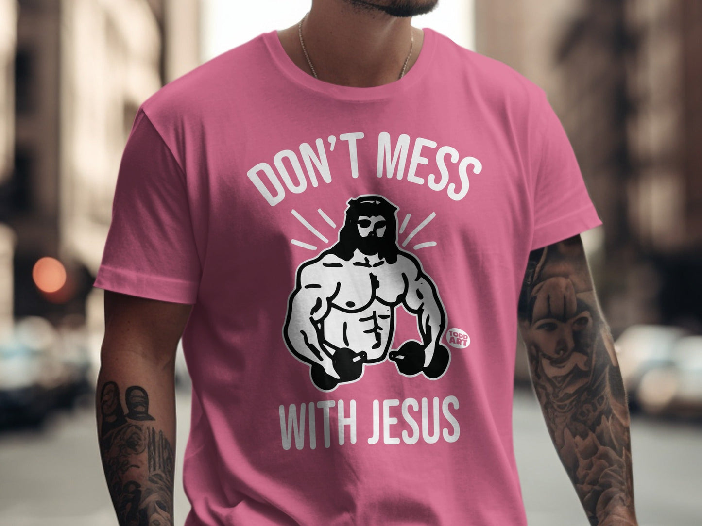 Pink t-shirt with "DON'T MESS WITH JESUS" text and a muscular Jesus graphic.