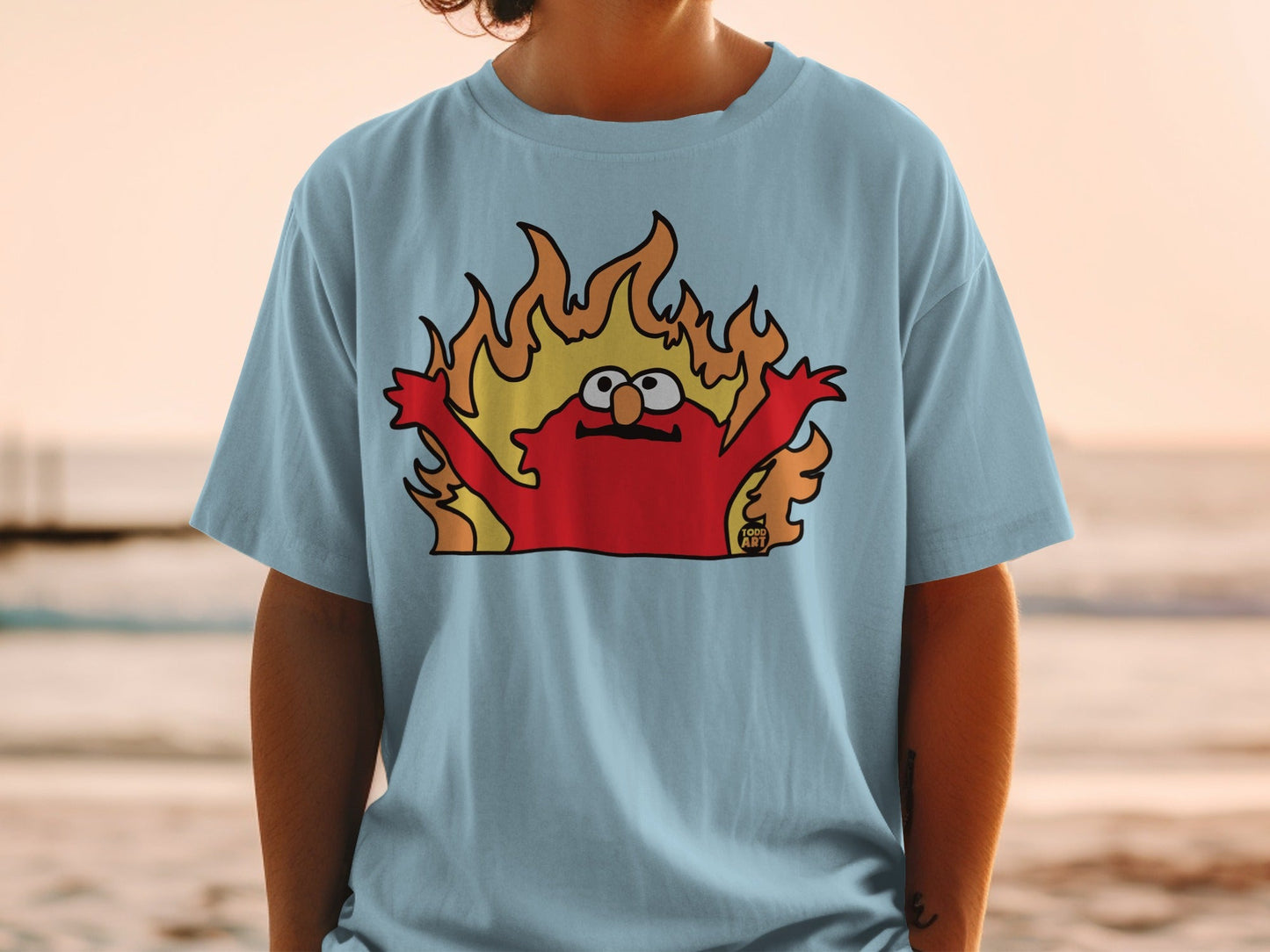 Light blue t-shirt with cartoon Elmo engulfed in flames.