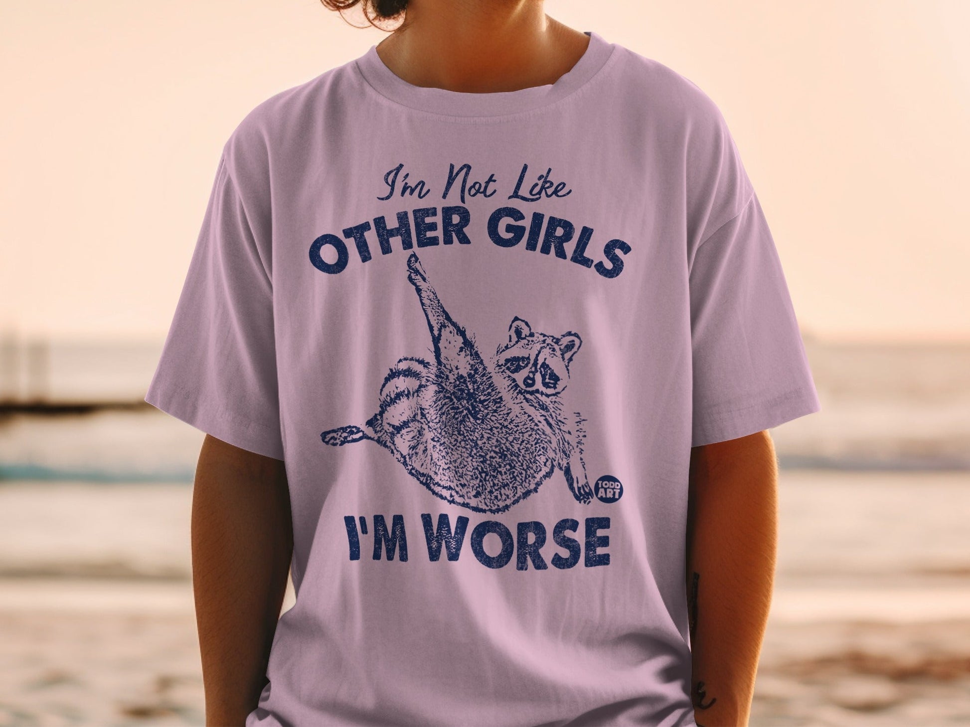 T-shirt with raccoon graphic and "I'm Not Like Other Girls I'm Worse" text.