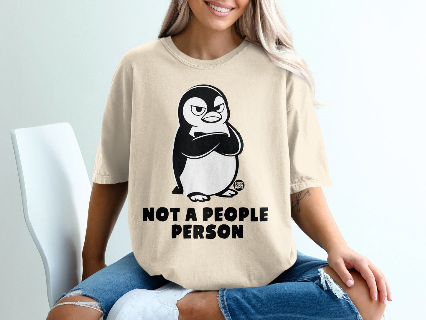 T-shirt with grumpy penguin graphic and "NOT A PEOPLE PERSON" text.
