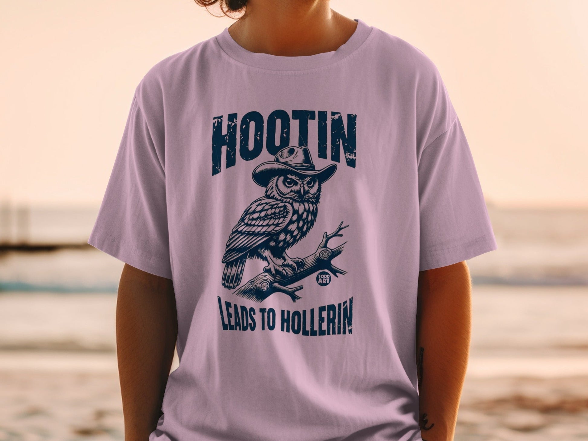 T-shirt graphic of an owl wearing a hat, with text "HOOTIN' LEADS TO HOLLERIN'".