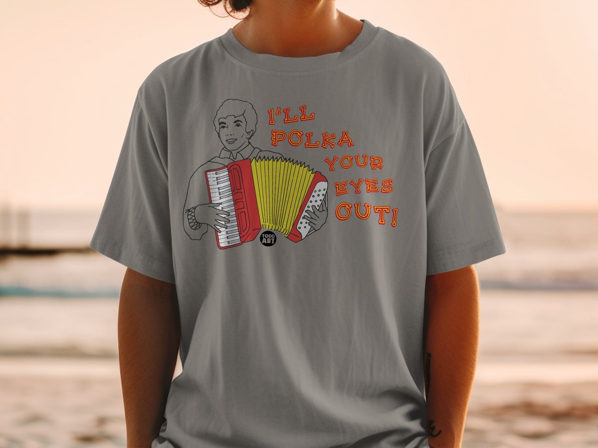 T-shirt with accordion player graphic and text: "I'LL POLKA YOUR EYES OUT!"