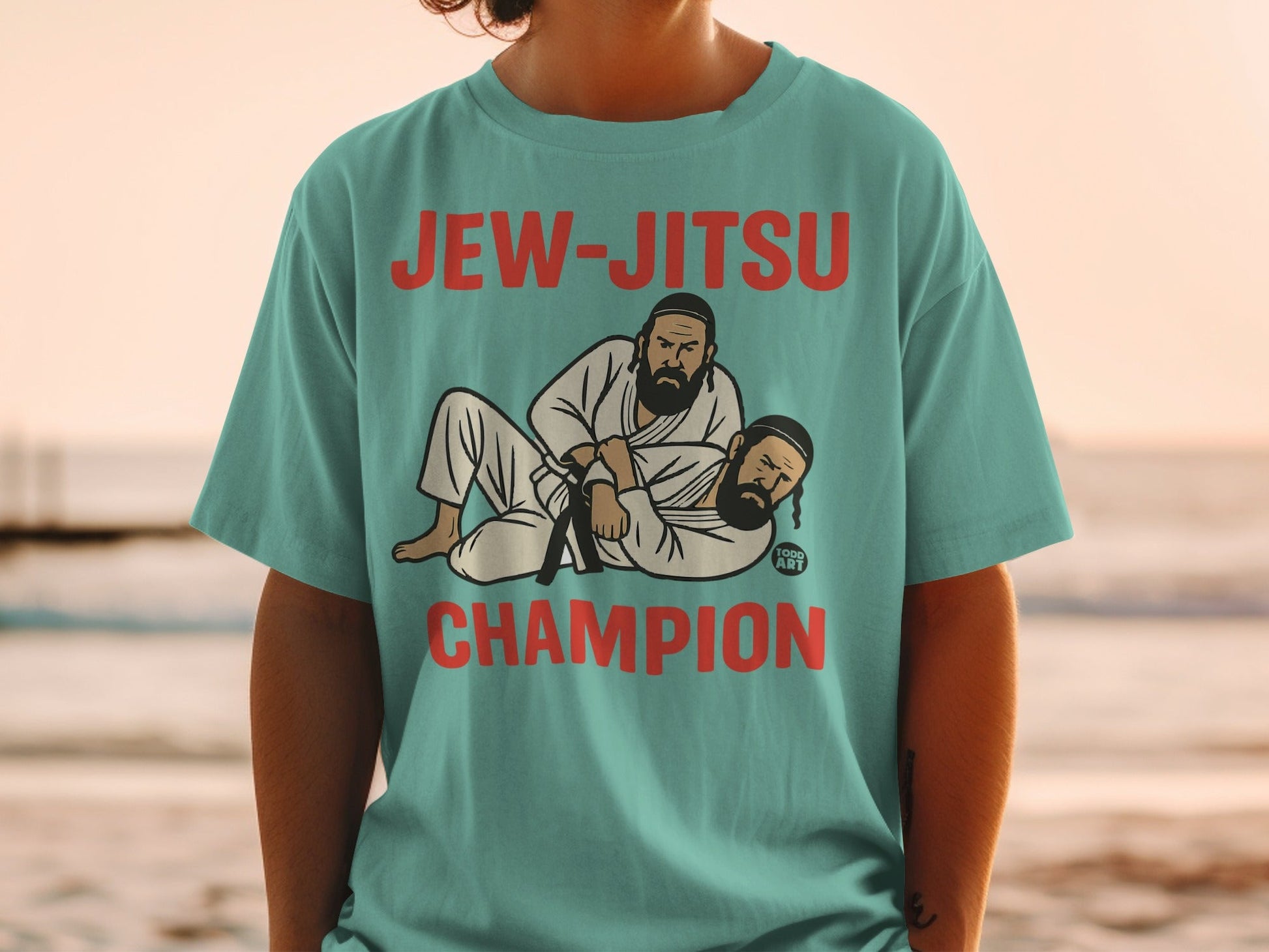 Teal t-shirt with "Jew-Jitsu Champion" and illustration of two men grappling.