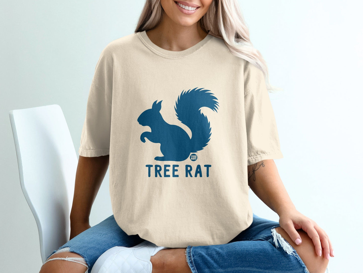 Tan t-shirt with blue squirrel graphic and "TREE RAT" text.