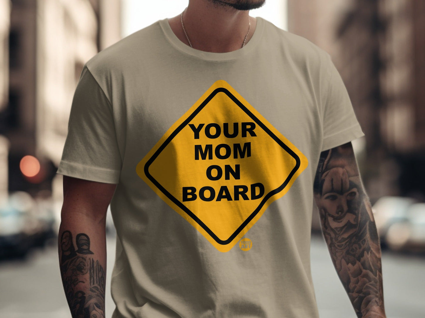 Yellow diamond sign with "YOUR MOM ON BOARD" text on a tan t-shirt.