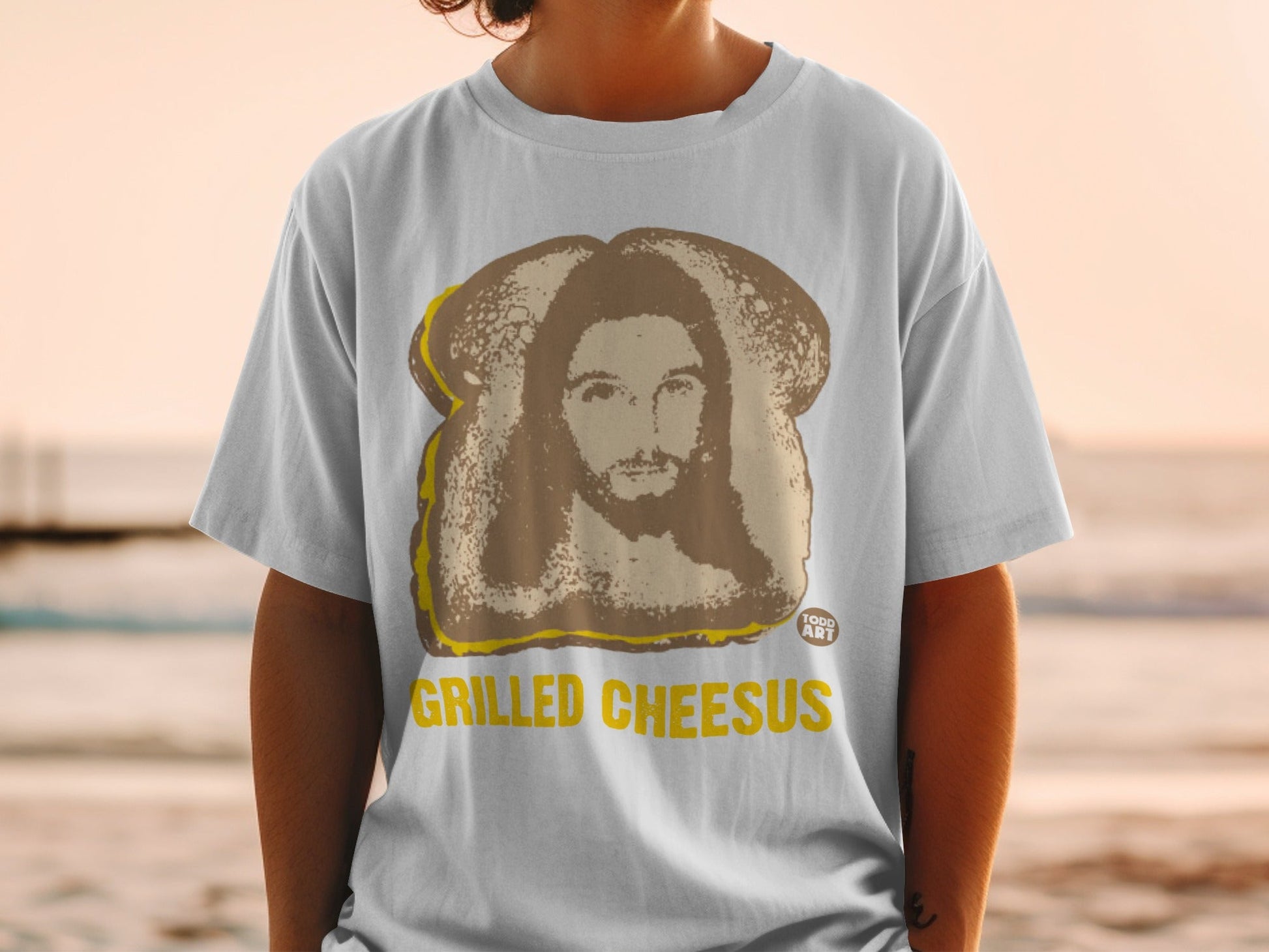 T-shirt with grilled cheese sandwich featuring Jesus on toast.