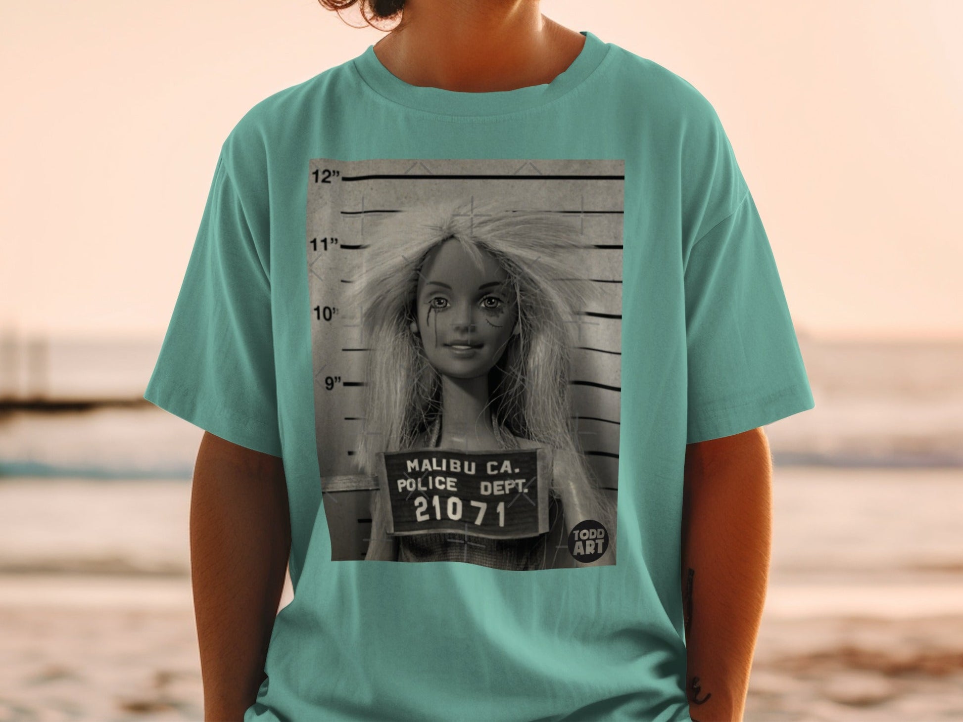 T-shirt with a Barbie doll mugshot and "Malibu CA. Police Dept. 21071" text.