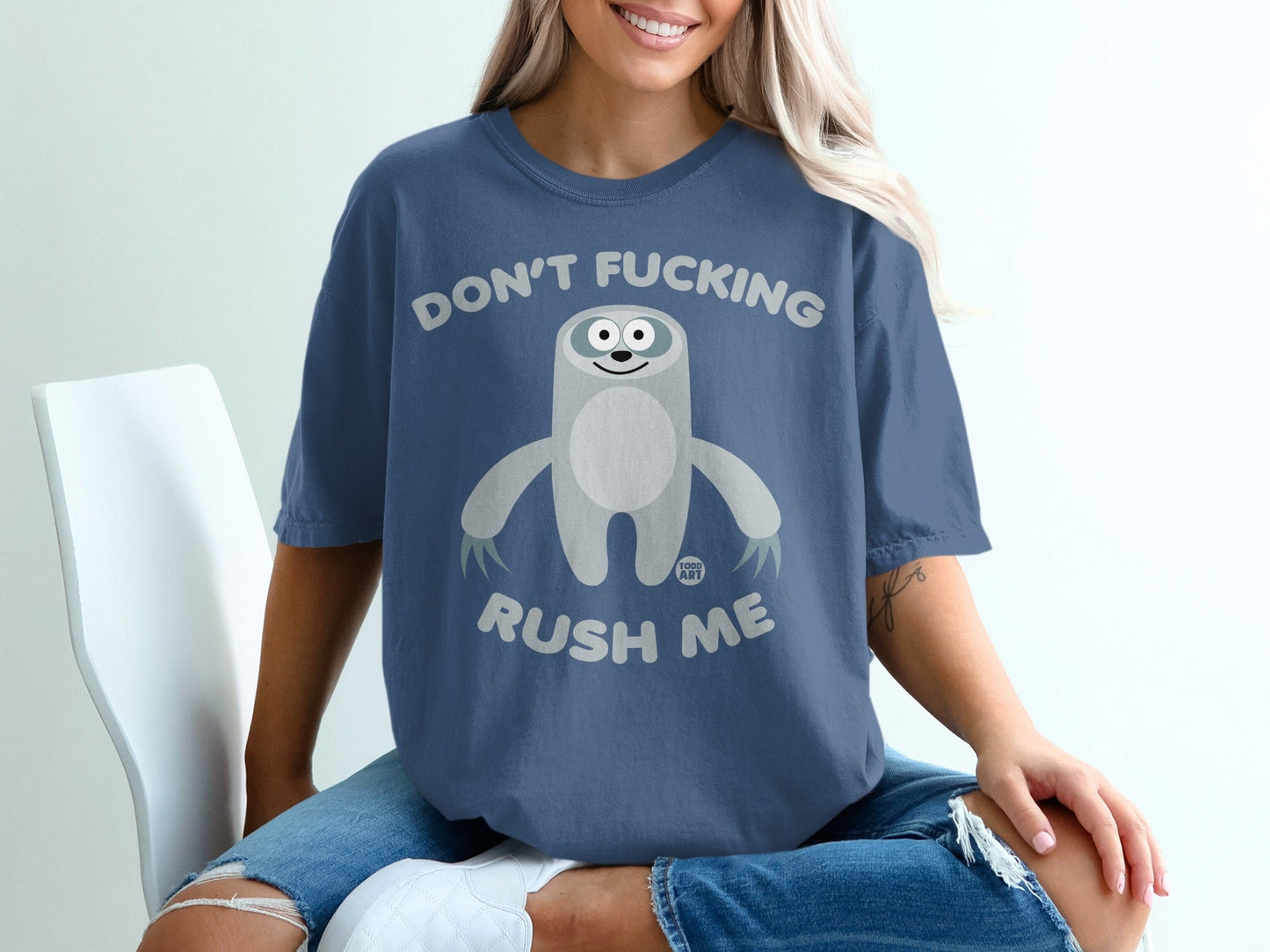Blue t-shirt with a cartoon sloth and text "Don't Fucking Rush Me".