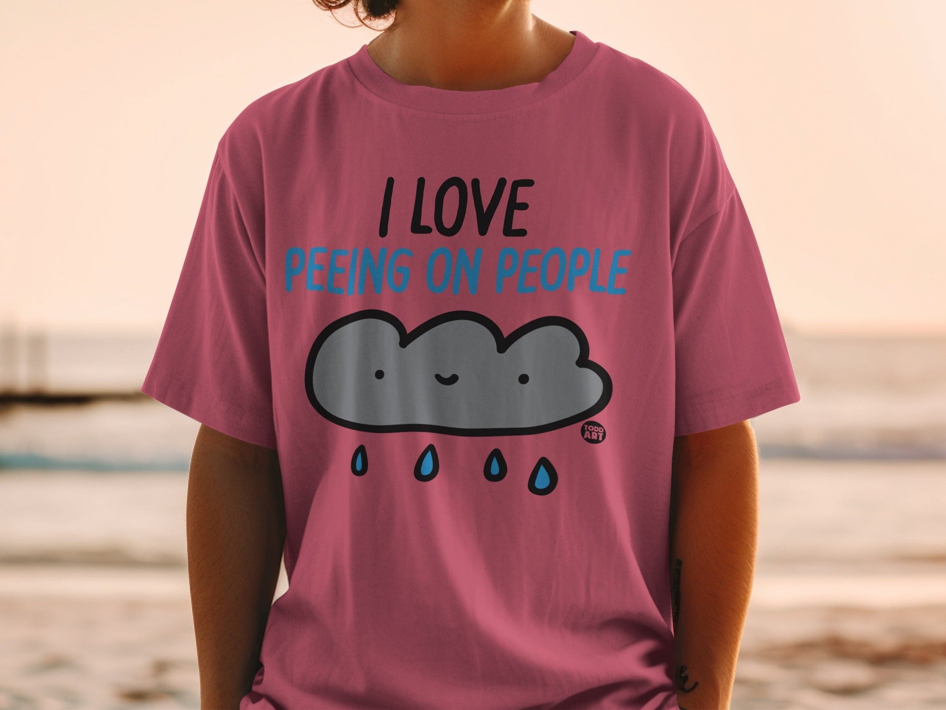 Pink t-shirt with a smiling cloud and "I LOVE peeing on people" text.