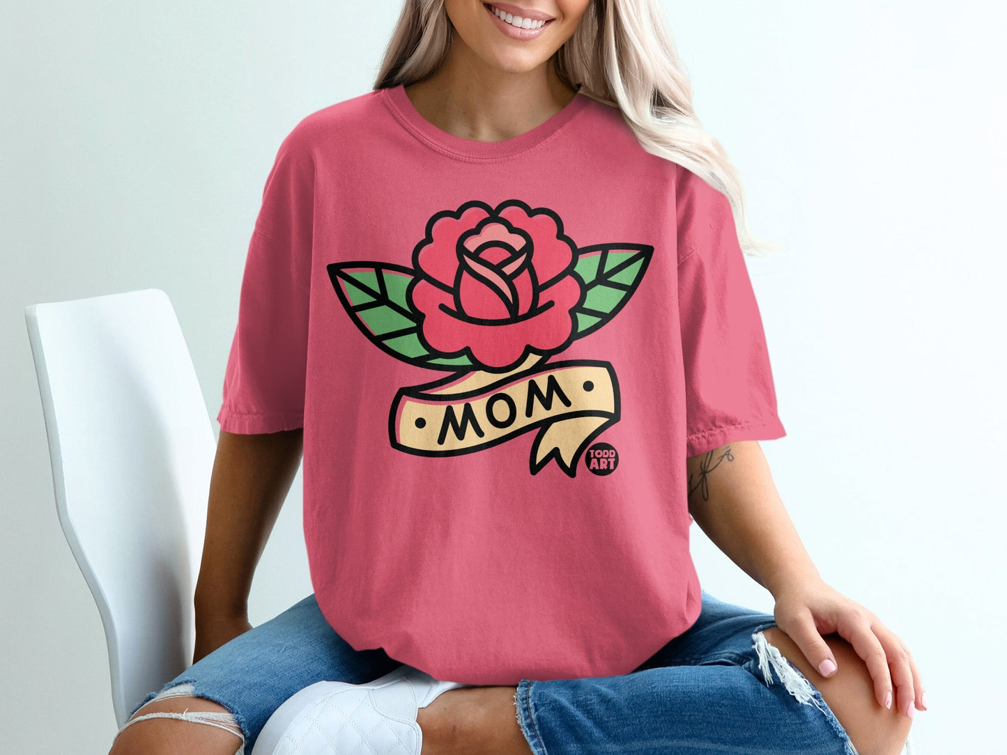 Pink t-shirt with rose and "MOM" tattoo-style banner design.