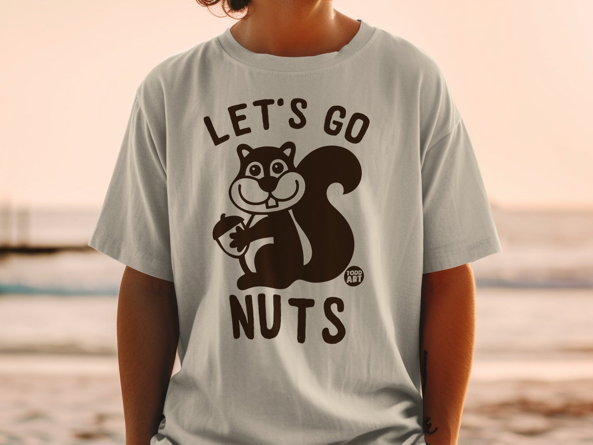 T-shirt with graphic of a squirrel holding an acorn and text "LET'S GO NUTS".