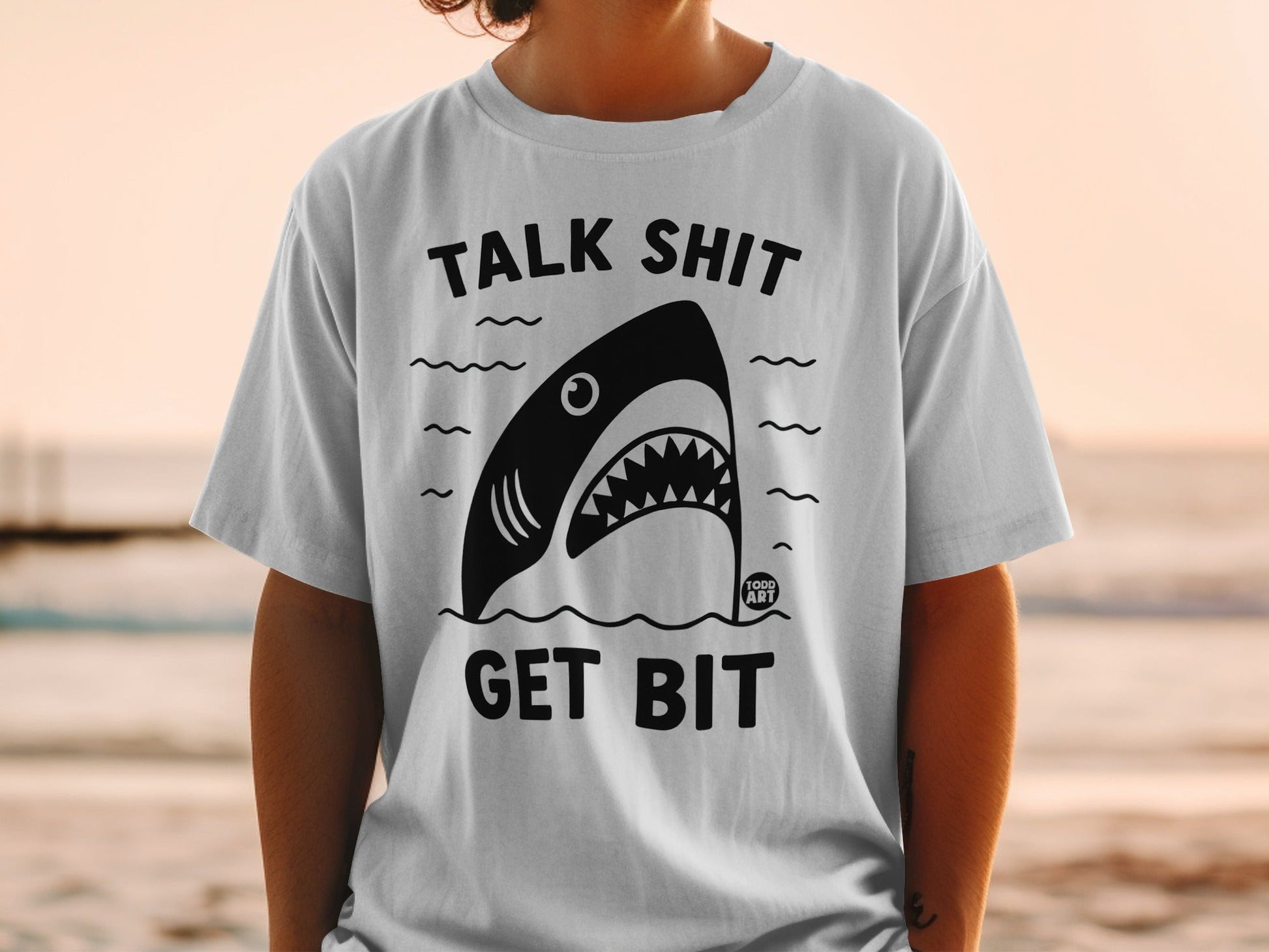 T-shirt with black shark graphic and text "TALK SHIT GET BIT".