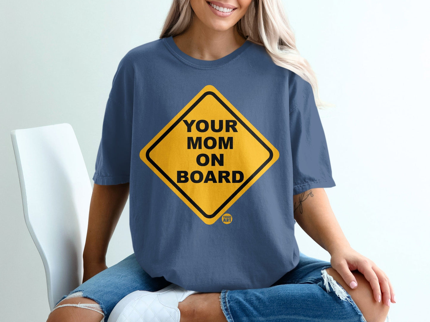 Yellow diamond sign with black text "YOUR MOM ON BOARD" and "ART" logo.