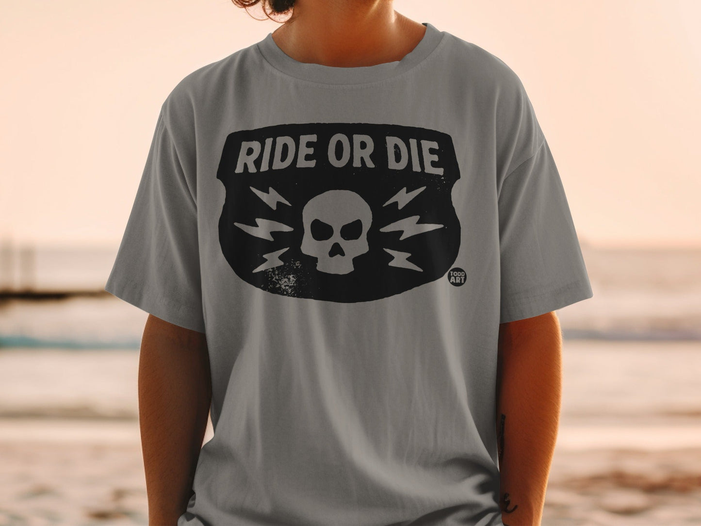Gray t-shirt with "RIDE OR DIE" and skull graphic.