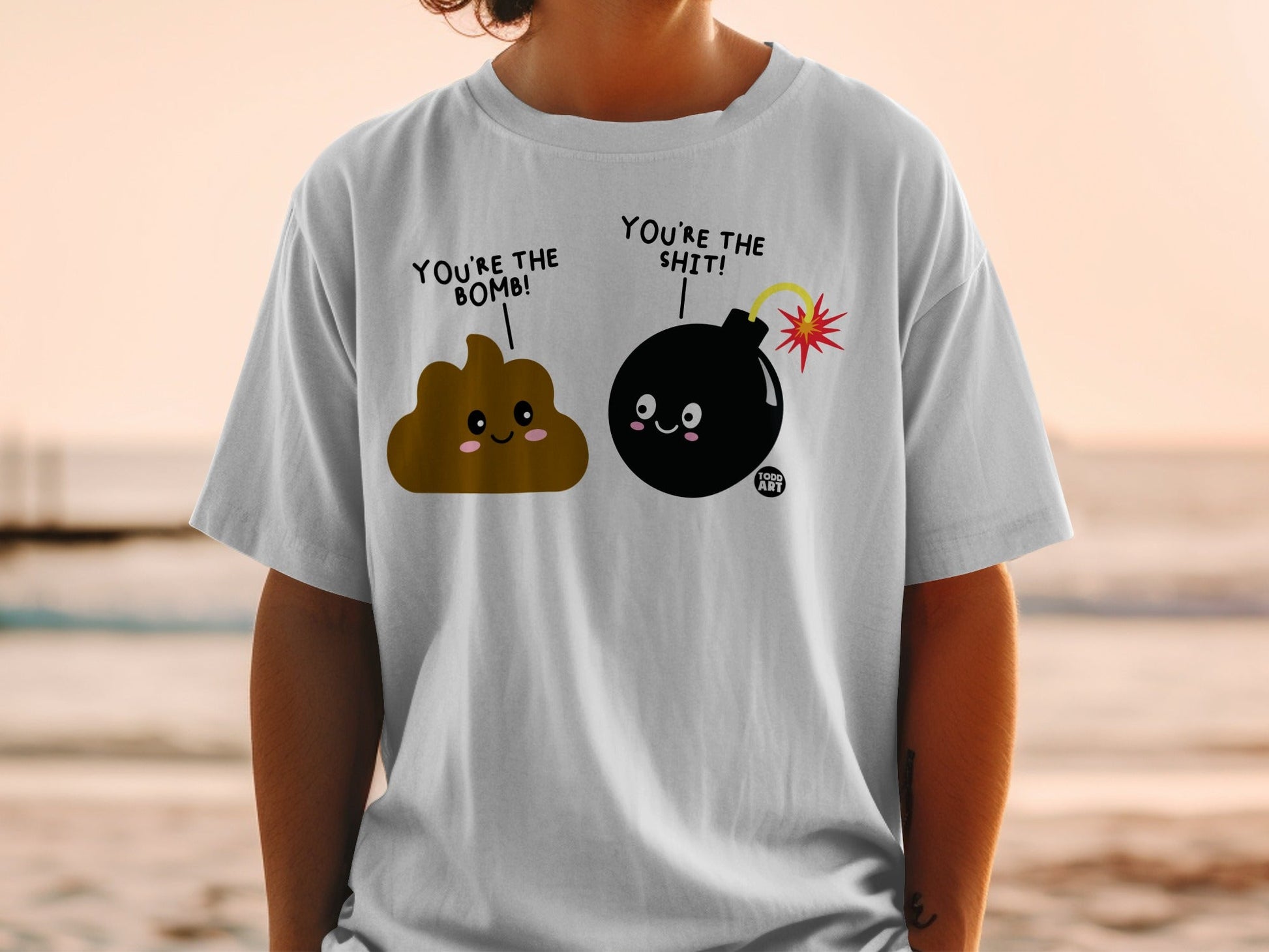 T-shirt with cartoon poop and bomb characters saying "You're the bomb!" and "You're the shit!".