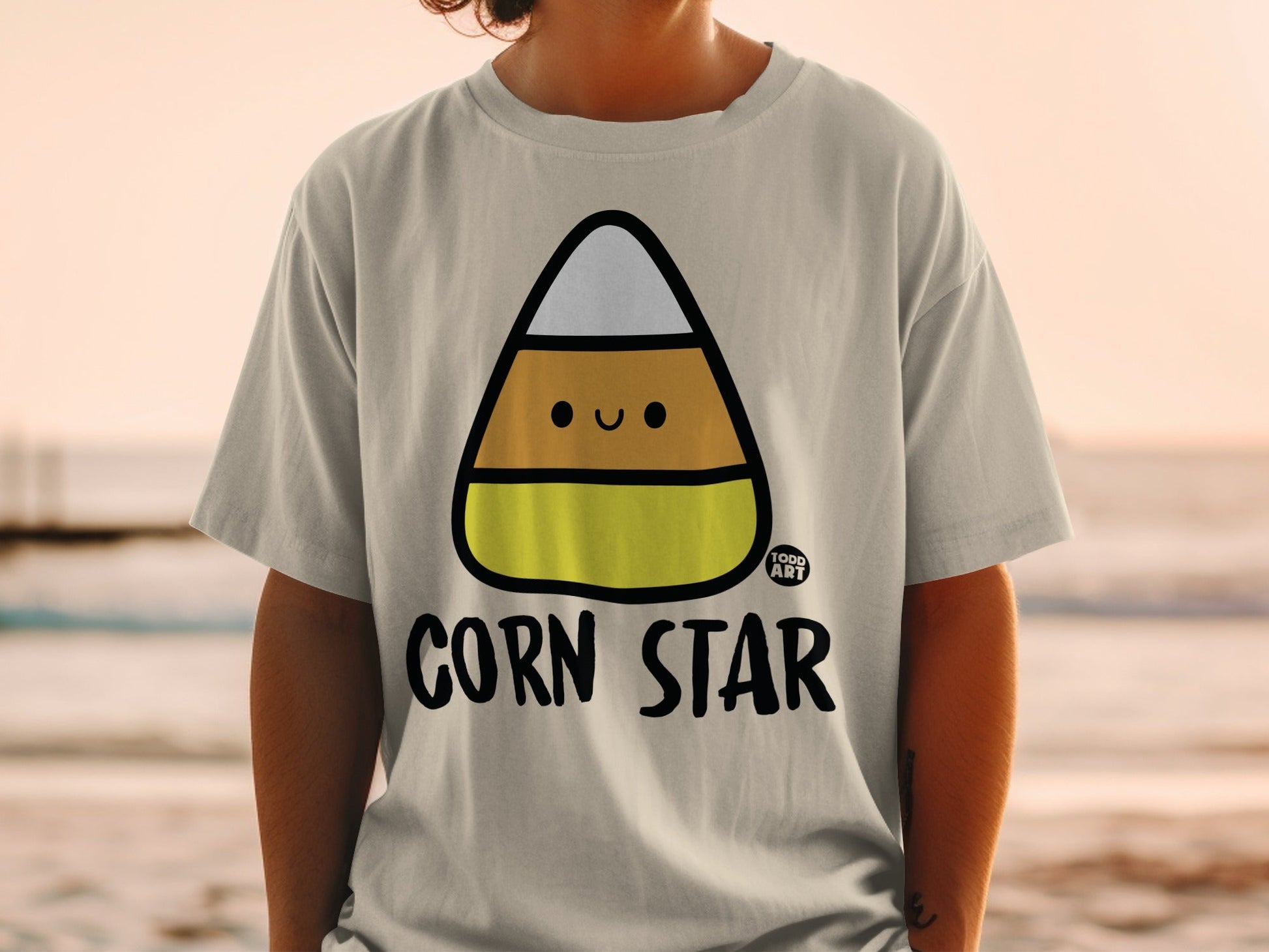 Cute Corn Star Graphic Tee with Smiling Candy Corn Image