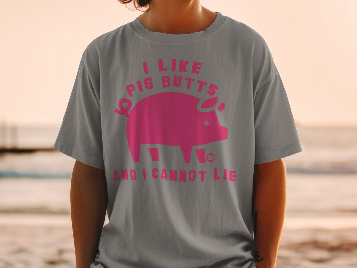 Grey t-shirt with pink text and pig graphic: "I like pig butts and I cannot lie".