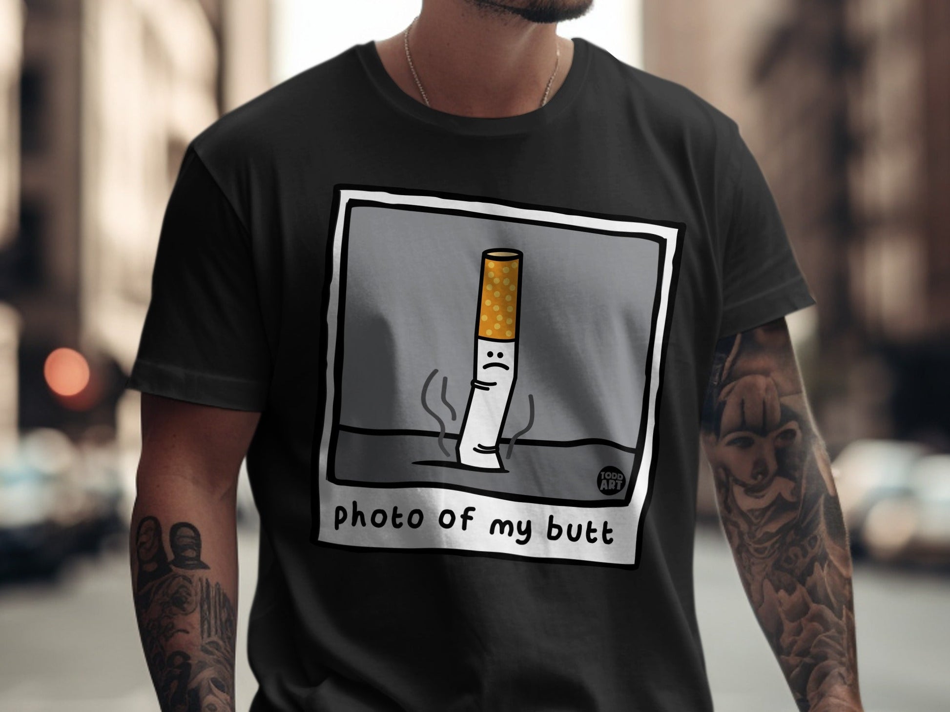 T-shirt graphic of a sad cigarette with the text "photo of my butt".