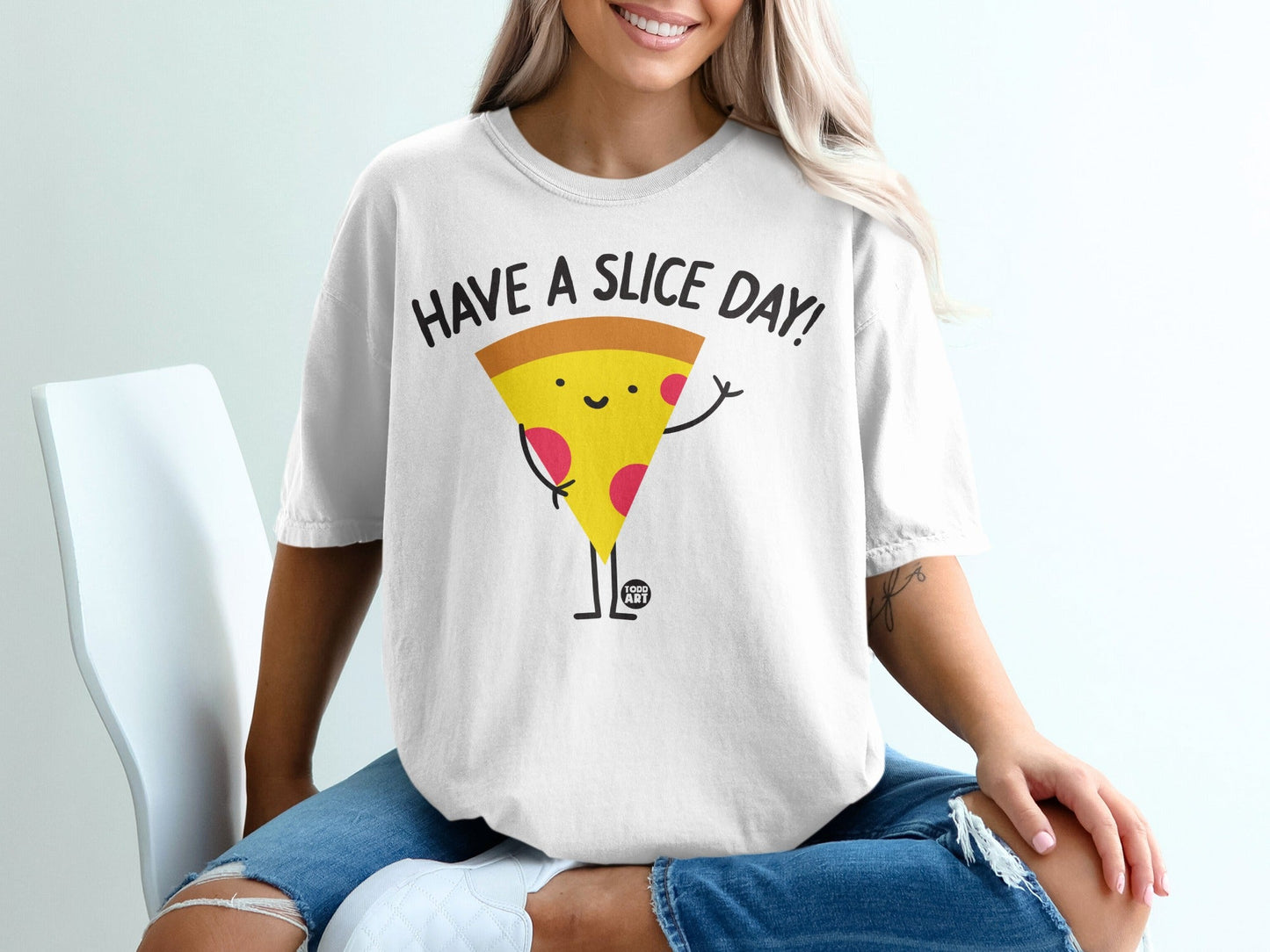 White t-shirt with "HAVE A SLICE DAY!" text and a smiling pizza slice graphic.