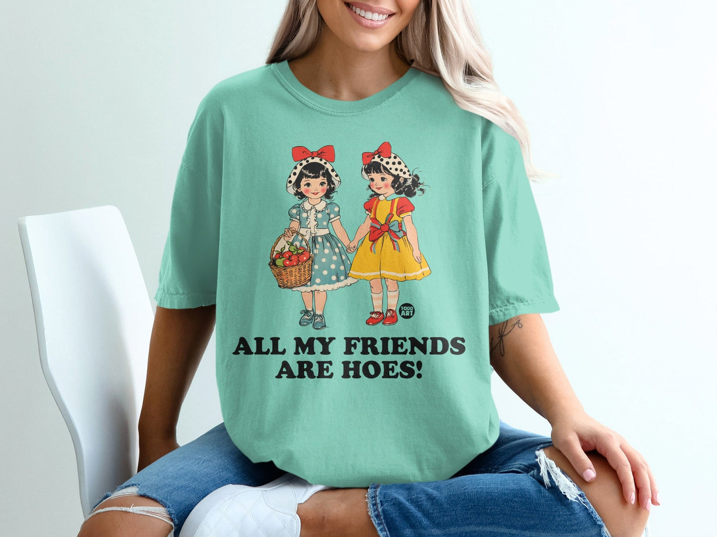 T-shirt with graphic of two girls in vintage dresses, text "ALL MY FRIENDS ARE HOES!".