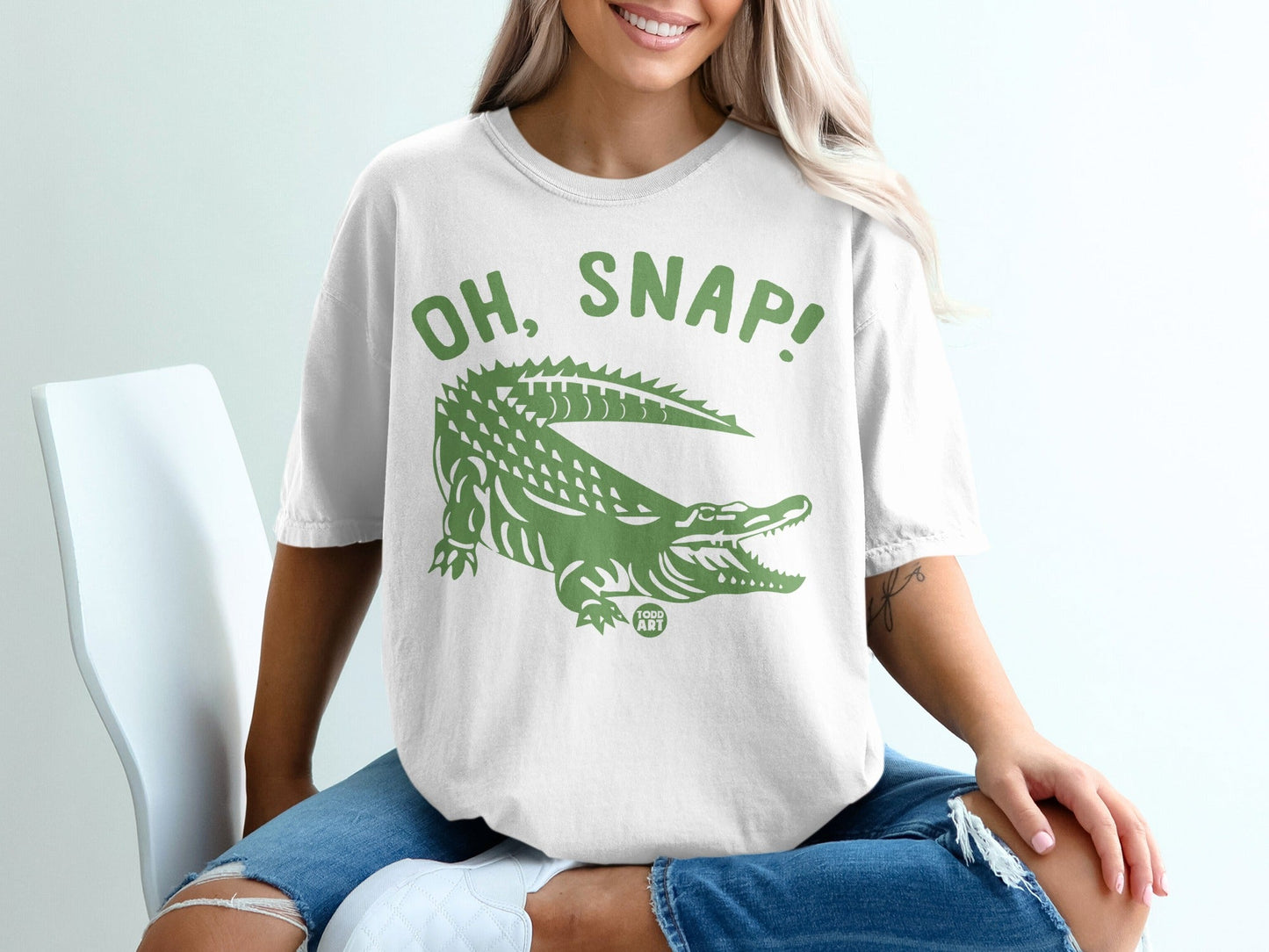 White t-shirt with green alligator graphic and "OH, SNAP!" text.