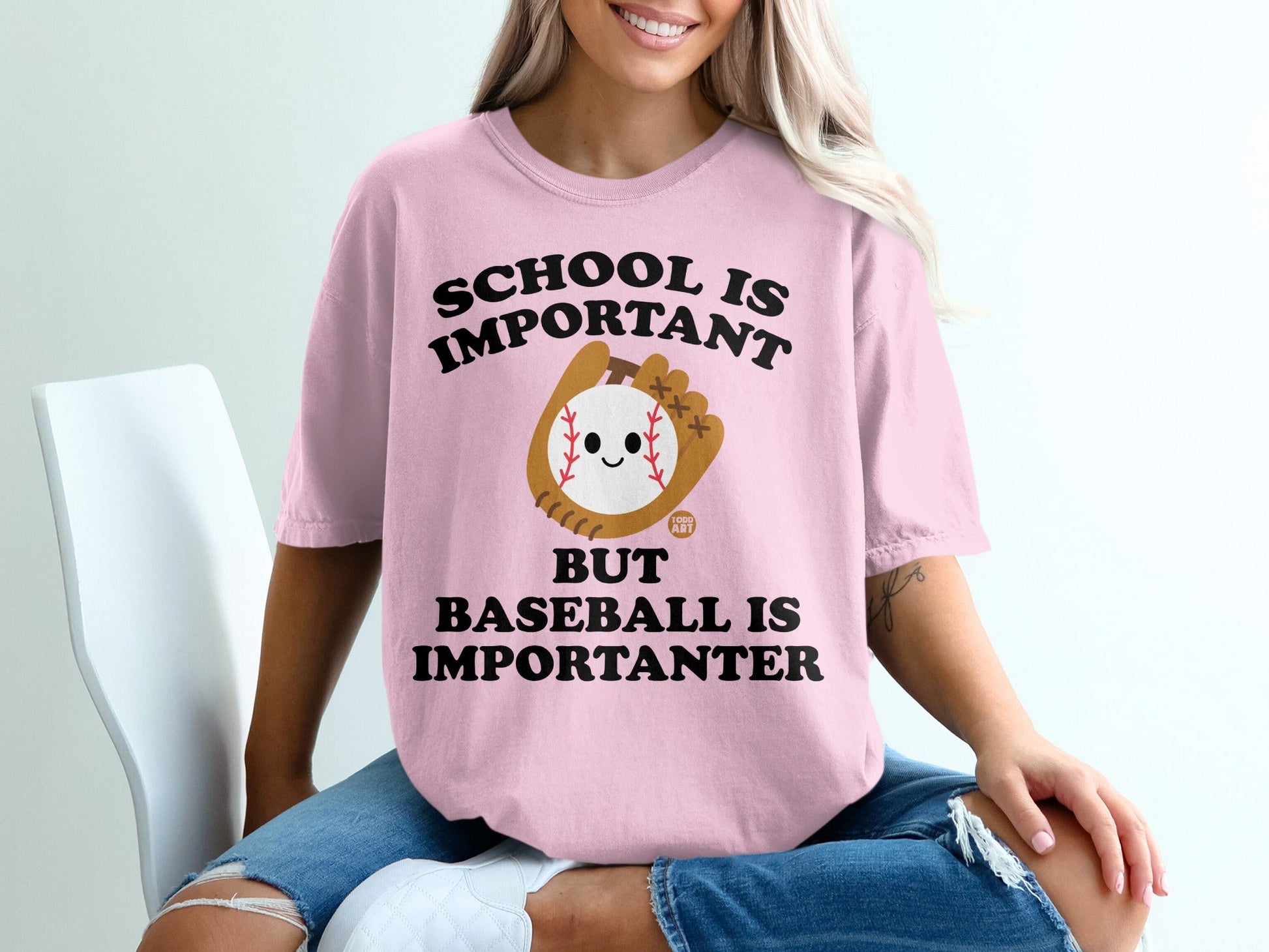 Pink t-shirt with "School is Important but Baseball is Importanter" text and baseball graphic.
