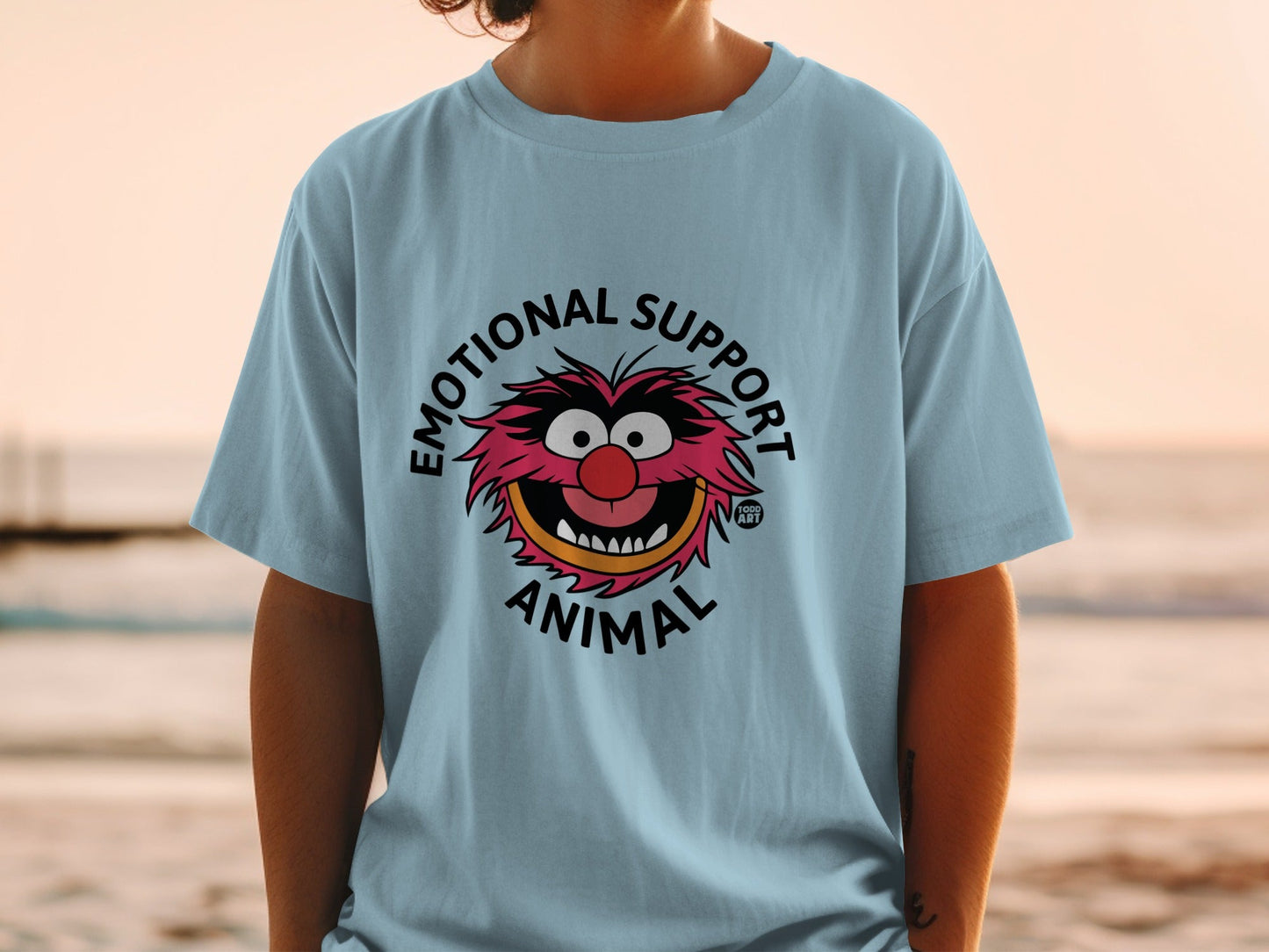Light blue t-shirt with "EMOTIONAL SUPPORT ANIMAL" and Muppet Animal character graphic.