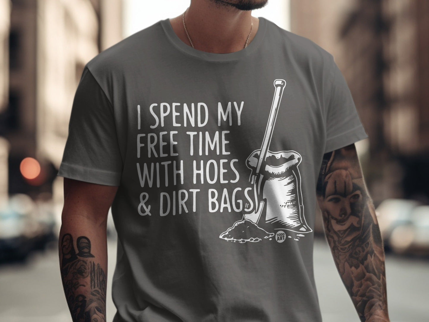 Gray t-shirt with "I spend my free time with hoes & dirt bags" text and shovel.