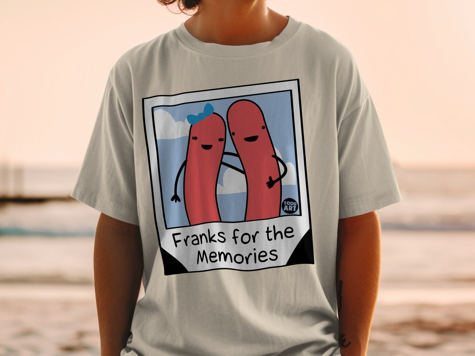 T-shirt with two hot dogs in a photo frame, "Franks for the Memories" text.