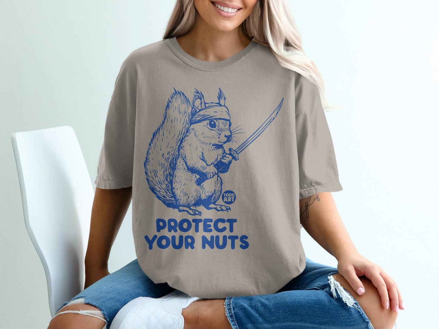 Squirrel in bandana holding sword with text "PROTECT YOUR NUTS".