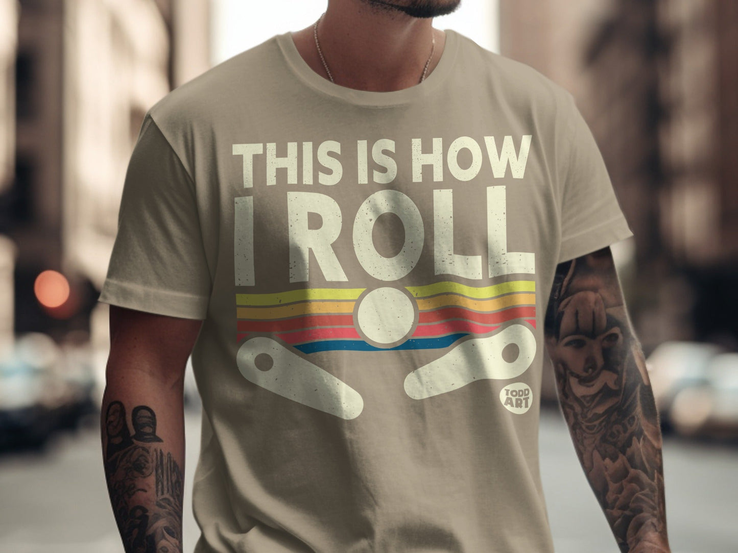 T-shirt with "THIS IS HOW I ROLL" text and pinball graphic.