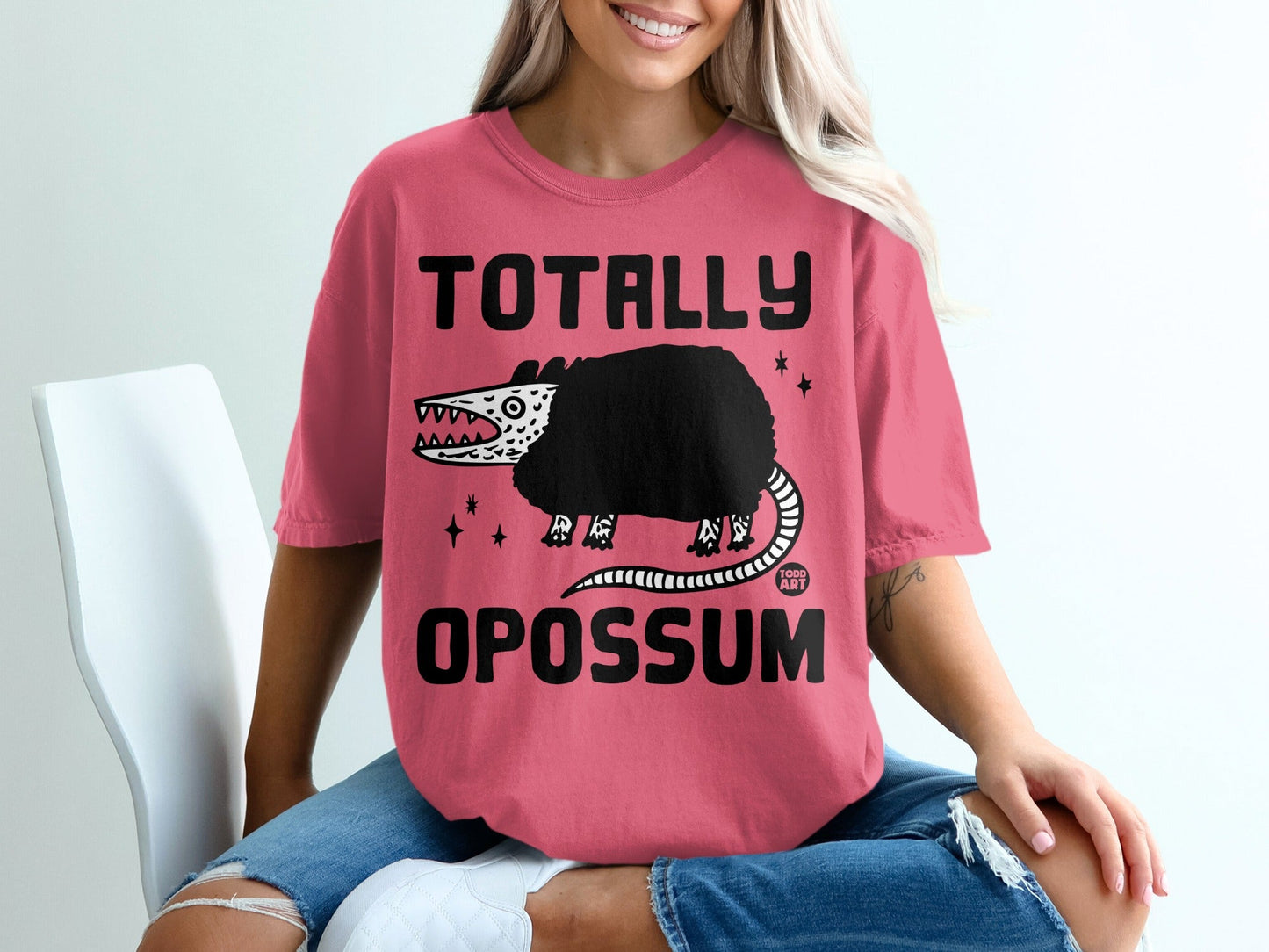 Pink t-shirt with "TOTALLY OPOSSUM" text and a cartoon opossum.