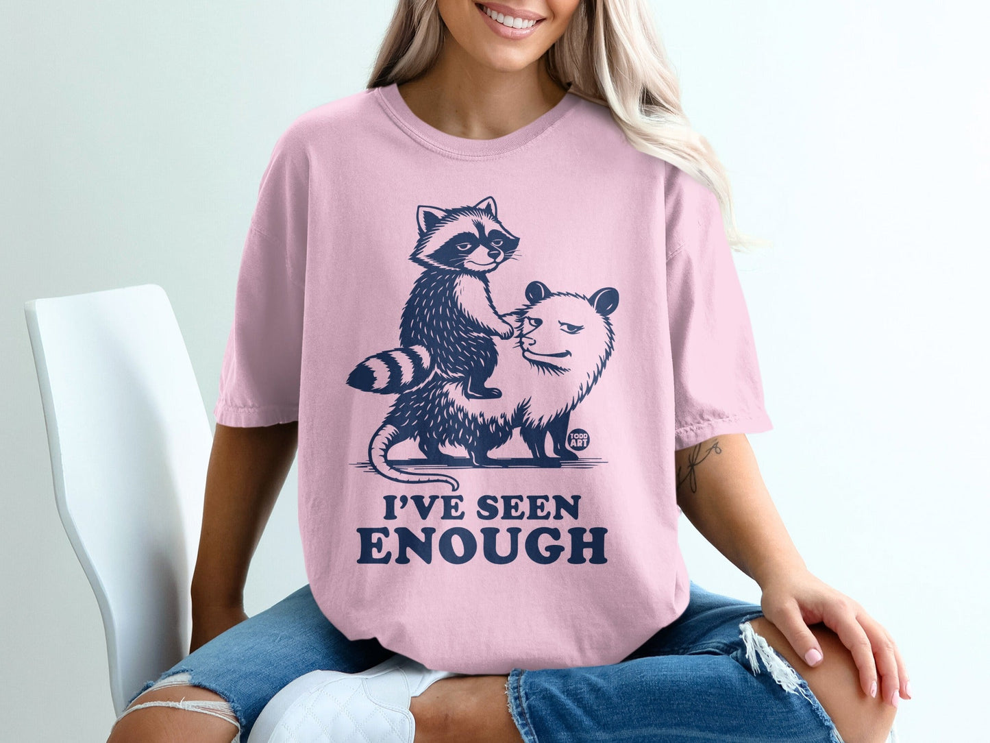 Pink t-shirt with raccoon riding an opossum, text "I'VE SEEN ENOUGH".