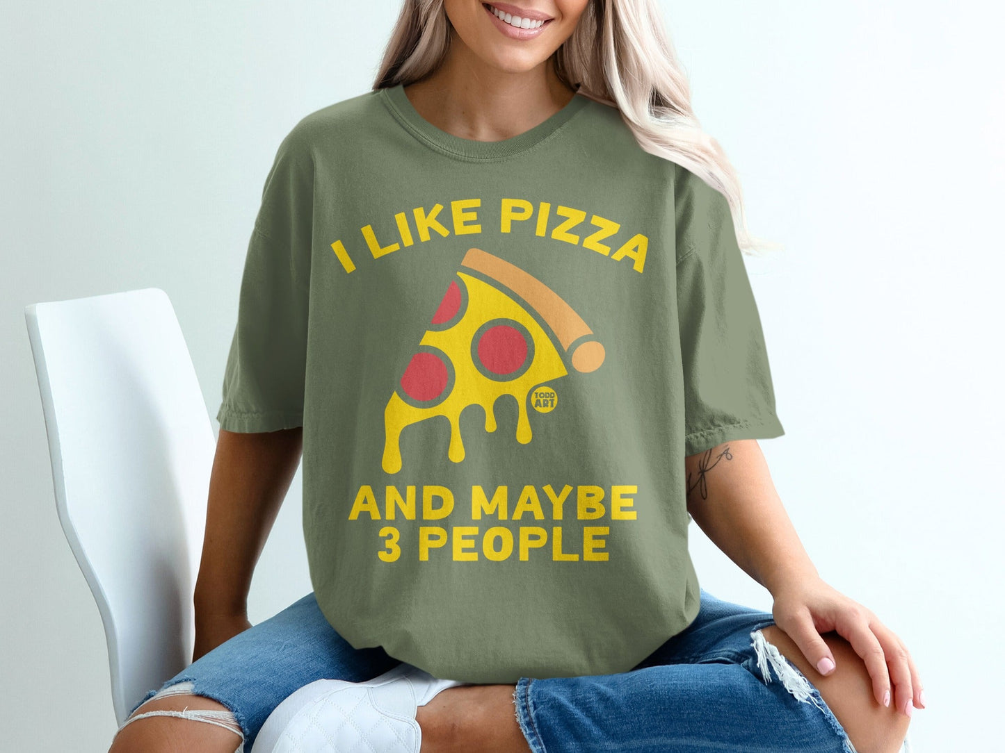 Olive green t-shirt with yellow text and pizza graphic saying "I like pizza and maybe 3 people".