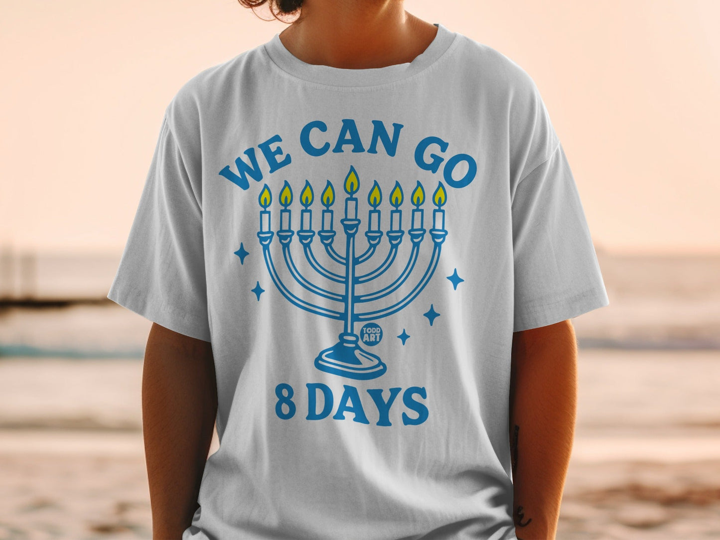 White t-shirt with menorah graphic and text "WE CAN GO 8 DAYS".