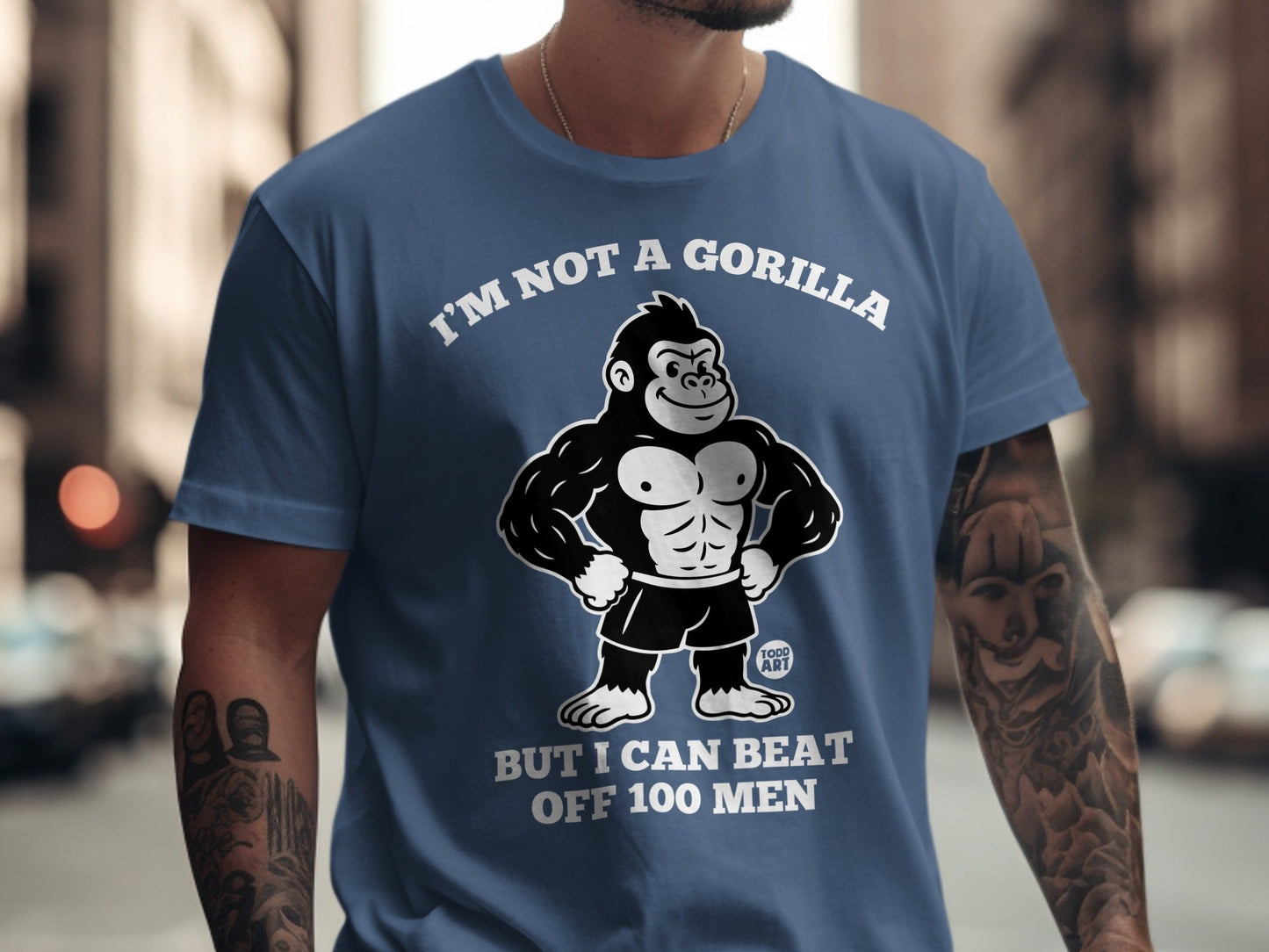 Blue t-shirt with gorilla graphic and text "I'm not a gorilla but I can beat off 100 men".