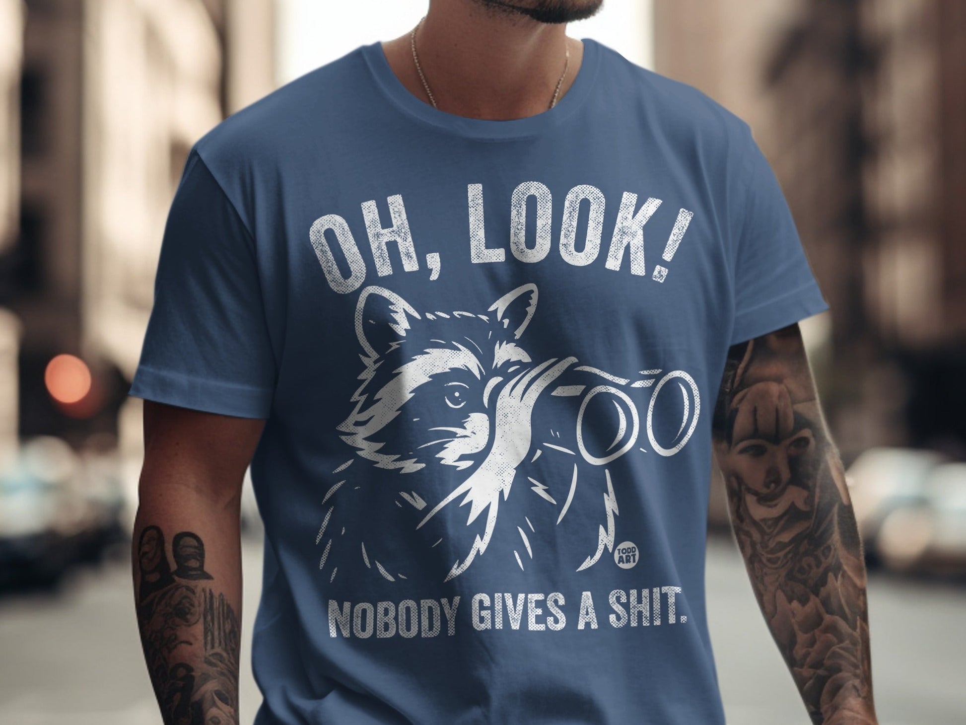 T-shirt with raccoon looking through binoculars and text "OH, LOOK! NOBODY GIVES A SHIT."