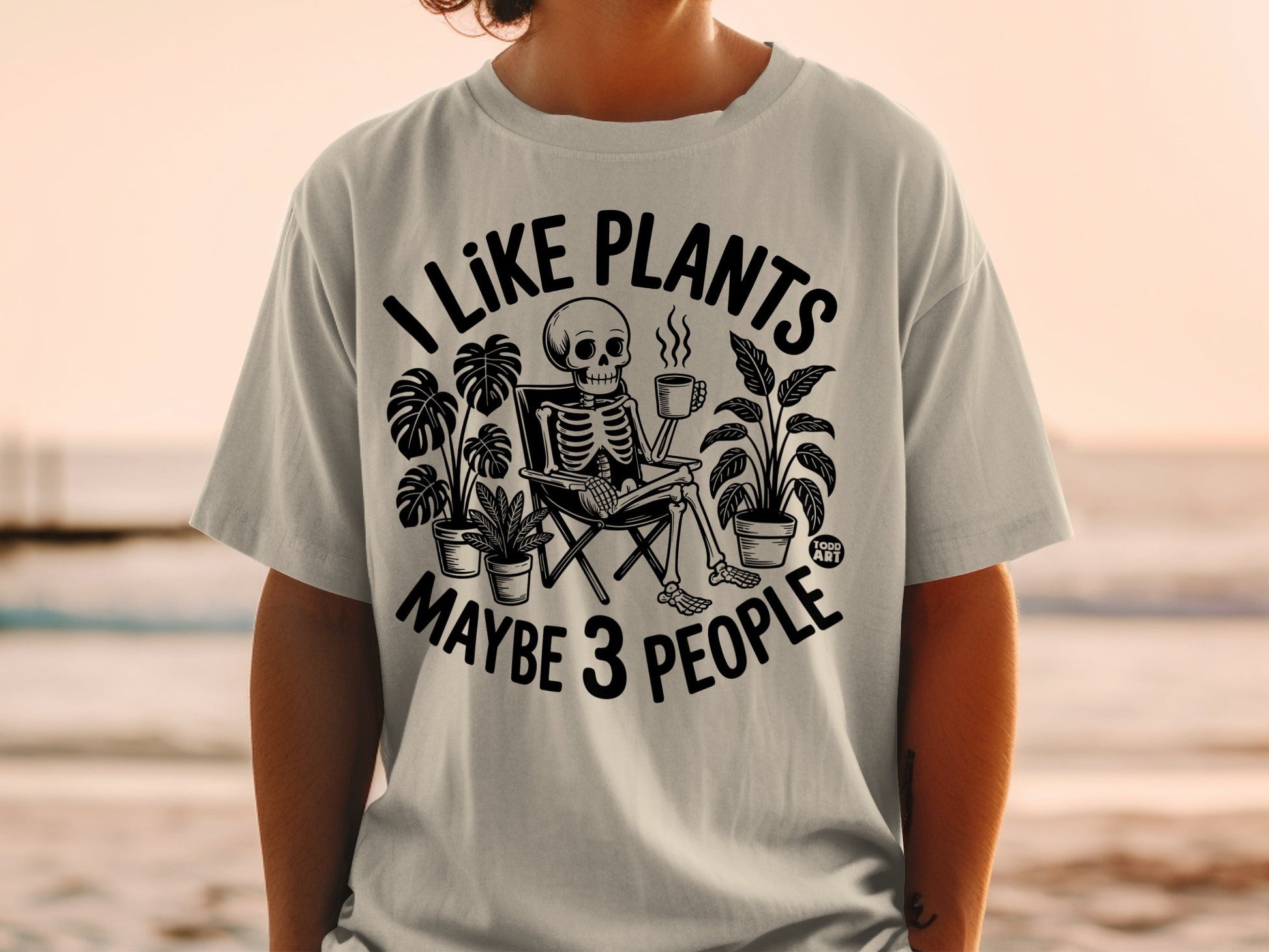 Skeleton in chair with plants, holding mug, text reads "I like plants maybe 3 people."
