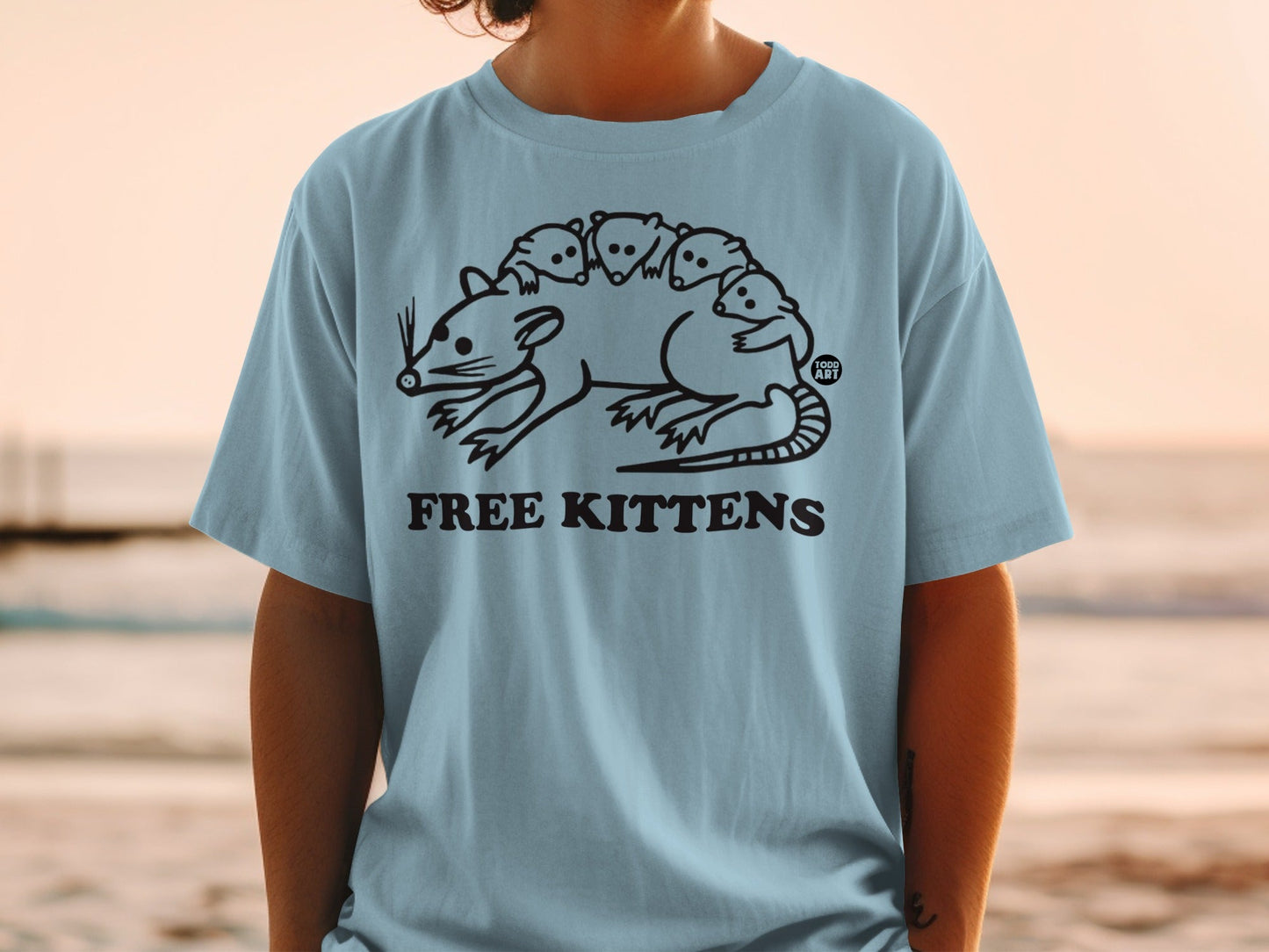 Light blue t-shirt with a black line drawing of a rat with kittens on its back.