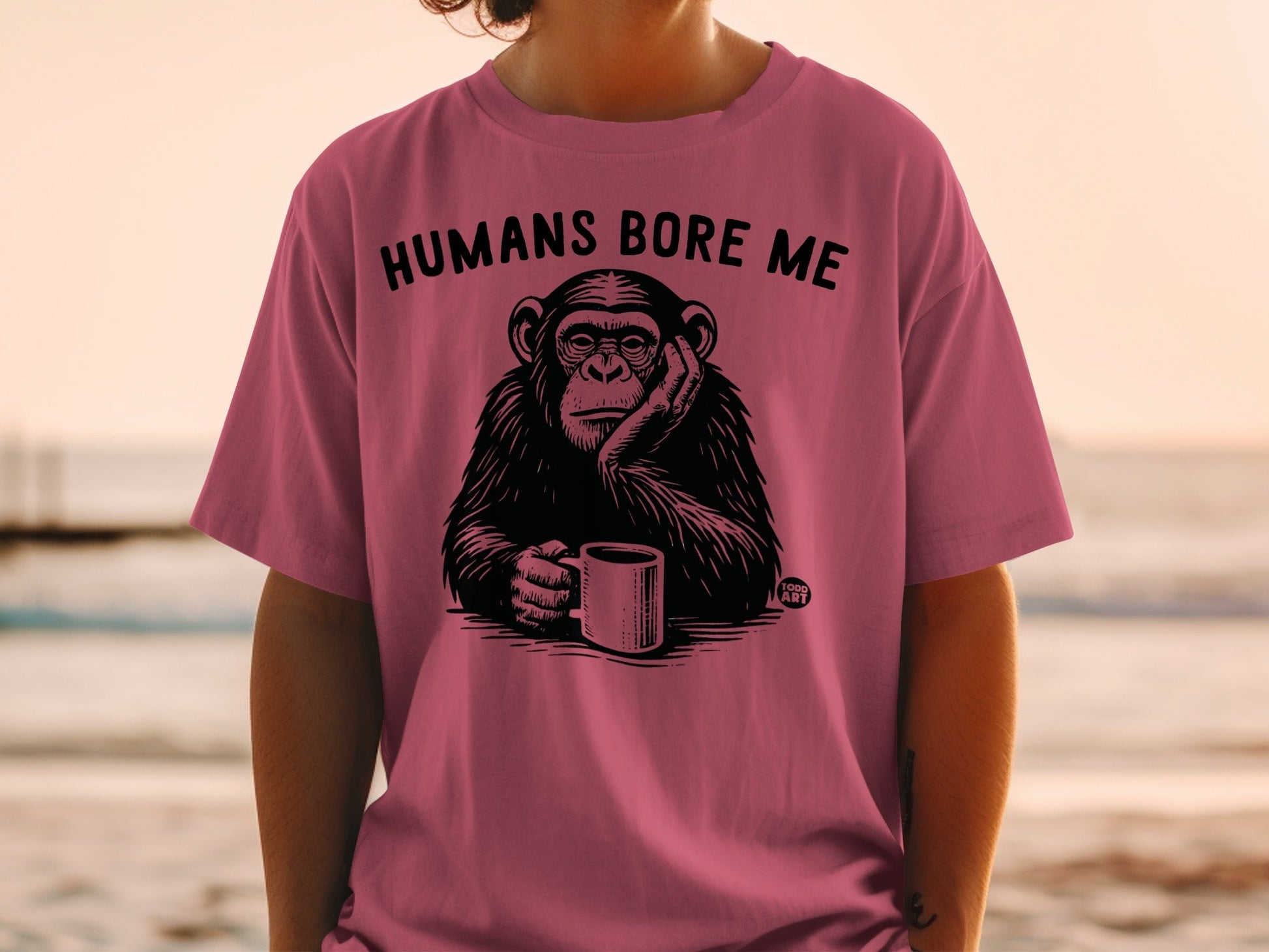 T-shirt with a bored chimpanzee holding a coffee mug and the text "HUMANS BORE ME".