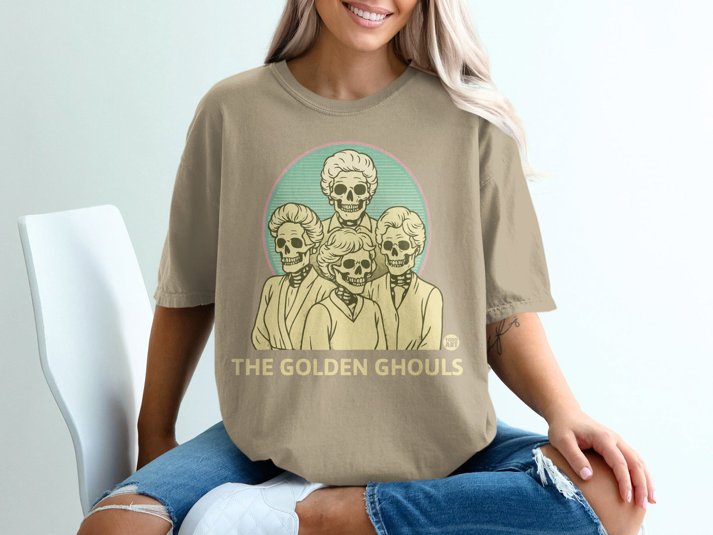T-shirt with "The Golden Ghouls" and stylized skull portraits.