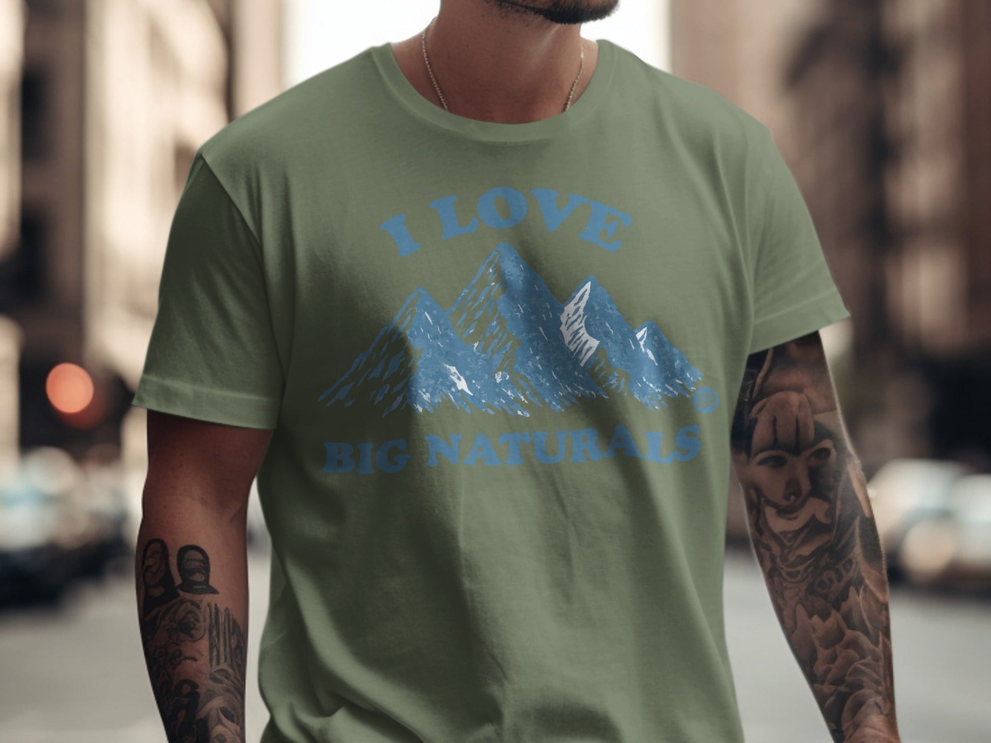 Green t-shirt with blue mountains and "I LOVE BIG NATURALS" text.