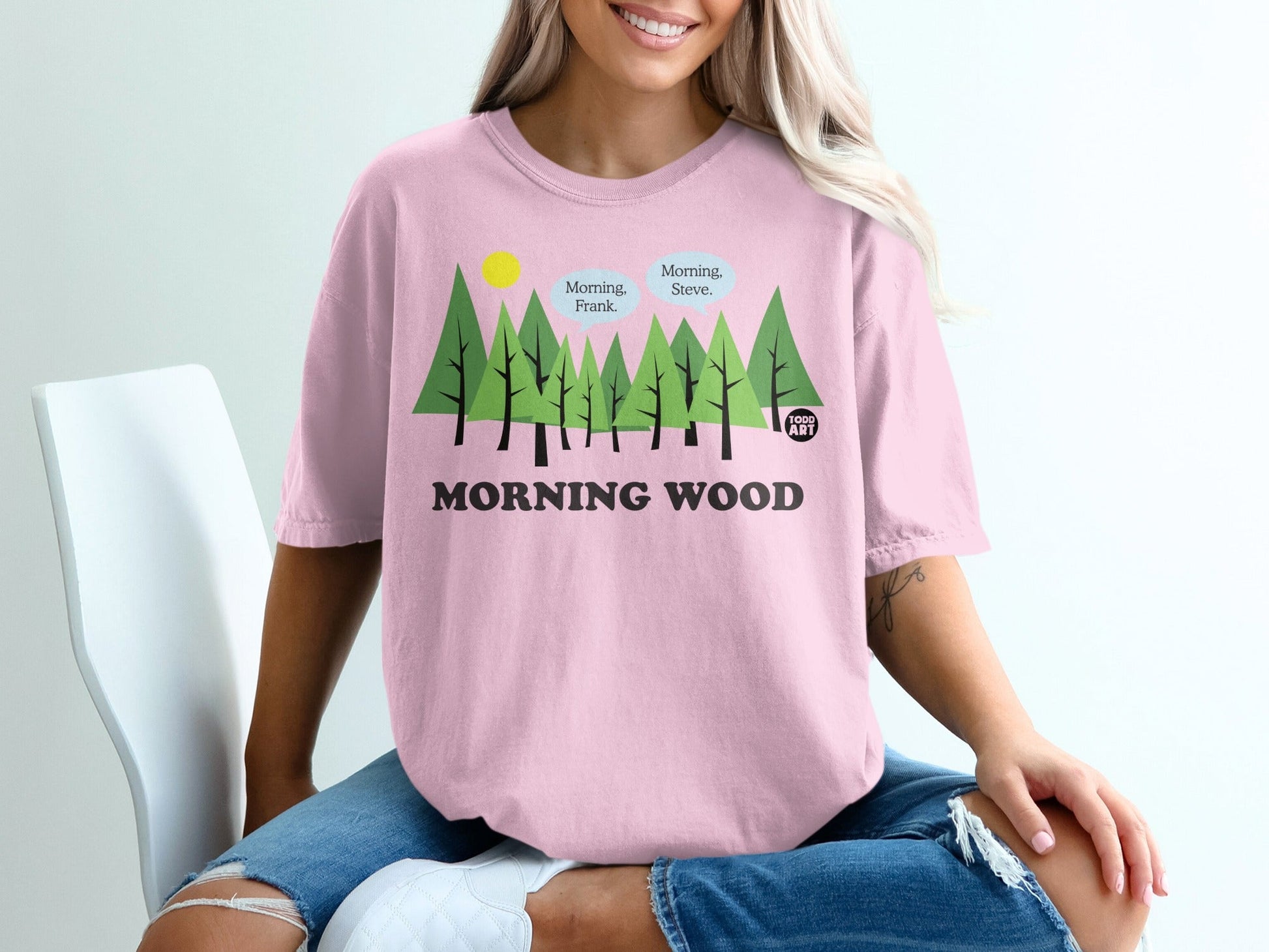 Pink t-shirt with "MORNING WOOD" and trees graphic.