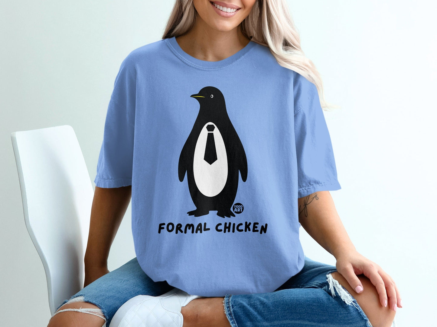 Blue t-shirt with a cartoon penguin wearing a tie and the text "FORMAL CHICKEN".