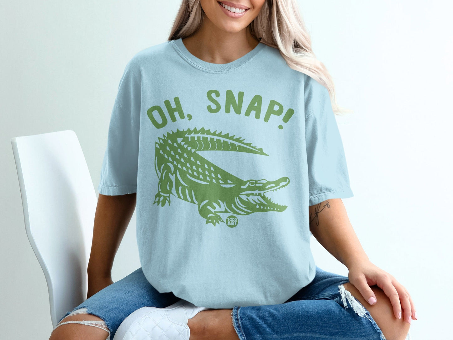 Light blue t-shirt with green "OH, SNAP!" alligator graphic.
